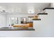 Well-lit kitchen featuring an island, stainless steel appliances, and convenient access to the backyard at 1444 W Wickieup Ln, Phoenix, AZ 85027