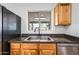 Close up view of the double sink with black faucet and view out the window to the backyard at 1444 W Wickieup Ln, Phoenix, AZ 85027