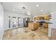 Open-concept kitchen with island, stainless steel appliances, and easy access to backyard at 1444 W Wickieup Ln, Phoenix, AZ 85027