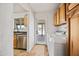 Laundry room features a washer and dryer, wooden cabinets, and tile flooring at 1444 W Wickieup Ln, Phoenix, AZ 85027