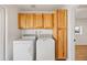 Functional laundry room with cabinetry and a side-by-side washer and dryer at 1444 W Wickieup Ln, Phoenix, AZ 85027