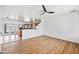 Spacious living room with light wood flooring, modern fan, and abundant natural light at 1444 W Wickieup Ln, Phoenix, AZ 85027