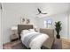 Inviting main bedroom with a cushioned headboard, neutral decor, and natural light at 1444 W Wickieup Ln, Phoenix, AZ 85027