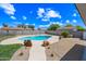 Inviting in-ground pool with lush landscaping and desert rock accents at 1444 W Wickieup Ln, Phoenix, AZ 85027
