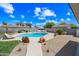 Relaxing pool area with lounge chairs, desert landscaping, and a clear blue sky at 1444 W Wickieup Ln, Phoenix, AZ 85027