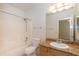 Bathroom with granite countertop, vanity, tub, and tiled shower at 15818 N 25Th St # 124, Phoenix, AZ 85032