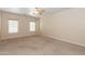 Bright bedroom with large windows, carpet and a ceiling fan at 15818 N 25Th St # 124, Phoenix, AZ 85032