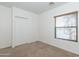 Neutral bedroom with carpet, window with blinds, and closet at 15818 N 25Th St # 124, Phoenix, AZ 85032