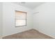 Bedroom with carpet, window with blinds, and closet at 15818 N 25Th St # 124, Phoenix, AZ 85032