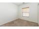 Bright bedroom featuring window with blinds and neutral carpet at 15818 N 25Th St # 124, Phoenix, AZ 85032