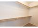 Bright walk-in closet with wooden rods, shelf, and neutral carpet at 15818 N 25Th St # 124, Phoenix, AZ 85032