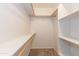 Well-lit walk-in closet featuring rod, shelf, and white storage shelves at 15818 N 25Th St # 124, Phoenix, AZ 85032