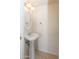 This half bath has a pedestal sink and an oval mirror with decorative lighting at 15818 N 25Th St # 124, Phoenix, AZ 85032