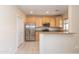 Open kitchen with stainless appliances, tile floors, granite counters and ample cabinets at 15818 N 25Th St # 124, Phoenix, AZ 85032