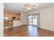 Open concept living room with wood floors, ceiling fan, and backyard access at 15818 N 25Th St # 124, Phoenix, AZ 85032