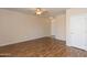 Spacious living room featuring modern ceiling fan and stylish wood-look flooring at 15818 N 25Th St # 124, Phoenix, AZ 85032