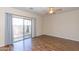 Bright living room with a ceiling fan, wood floors and sliding glass doors to the backyard at 15818 N 25Th St # 124, Phoenix, AZ 85032
