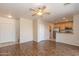 Spacious living room with wood floors, opening to the kitchen with stainless appliances at 15818 N 25Th St # 124, Phoenix, AZ 85032