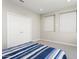 Bedroom featuring double doors to closet space and bright windows at 16953 W Merrell St, Goodyear, AZ 85395