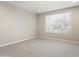 Bright bedroom with neutral walls, carpet, and a window at 16953 W Merrell St, Goodyear, AZ 85395