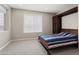 Neutral bedroom with a striped bed and cabinet at 16953 W Merrell St, Goodyear, AZ 85395