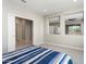 Bedroom featuring sliding door access to the hall and windows to the outdoors at 16953 W Merrell St, Goodyear, AZ 85395