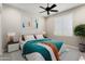 Cozy bedroom with a fan, bed, and window at 16953 W Merrell St, Goodyear, AZ 85395