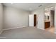 Spacious carpeted bedroom leading to a bathroom and closet at 16953 W Merrell St, Goodyear, AZ 85395