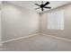 Carpeted bedroom with a window and ceiling fan at 16953 W Merrell St, Goodyear, AZ 85395