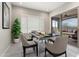 Dining area with modern table, chairs, and sliding glass doors to a patio at 16953 W Merrell St, Goodyear, AZ 85395