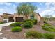 Charming single-story home with desert landscaping, a well-maintained lawn, and a three car garage at 16953 W Merrell St, Goodyear, AZ 85395