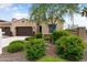 Beautiful home featuring a well-manicured lawn, desert landscaping, and a two-car garage at 16953 W Merrell St, Goodyear, AZ 85395