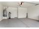 Bright garage featuring an epoxy floor, water filtration system, and water heater at 16953 W Merrell St, Goodyear, AZ 85395