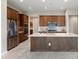 Spacious kitchen features stainless steel appliances, a large island, and wood cabinetry at 16953 W Merrell St, Goodyear, AZ 85395