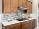 Detailed view of the kitchen showcasing the gas range, tile backsplash, and ample cabinet space at 16953 W Merrell St, Goodyear, AZ 85395