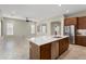 Open concept kitchen with an island, stainless steel appliances, and dark wood cabinetry at 16953 W Merrell St, Goodyear, AZ 85395