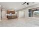 Bright kitchen with island, stone backsplash, and views of the spacious living area at 16953 W Merrell St, Goodyear, AZ 85395
