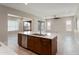 Kitchen island with sink and dishwasher, connecting to a bright living area and sliding glass doors at 16953 W Merrell St, Goodyear, AZ 85395