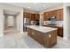 Bright kitchen with a large center island, stainless appliances, and wood cabinets at 16953 W Merrell St, Goodyear, AZ 85395
