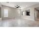 Generously sized living room with tile flooring, neutral paint, and a ceiling fan at 16953 W Merrell St, Goodyear, AZ 85395