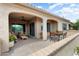 Inviting covered patio with comfortable seating and a dining area at 16953 W Merrell St, Goodyear, AZ 85395