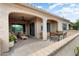 Cozy covered patio with comfortable seating and an outdoor dining area perfect for entertaining at 16953 W Merrell St, Goodyear, AZ 85395