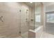 Walk-in shower featuring glass doors and tiled walls at 16953 W Merrell St, Goodyear, AZ 85395