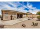 Backyard featuring desert landscaping, neutral stucco, and extended patio with covered area at 17773 W Manso St, Goodyear, AZ 85338