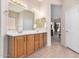 Well-lit bathroom features a double sink vanity, neutral paint and direct access to the house interior at 17773 W Manso St, Goodyear, AZ 85338