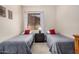 Comfortable bedroom featuring twin beds, a neutral palette, a dresser, and plenty of natural light at 17773 W Manso St, Goodyear, AZ 85338