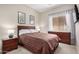 Relaxing bedroom featuring a wooden bed frame, dark wood furniture, and soft lighting at 17773 W Manso St, Goodyear, AZ 85338