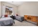 Comfortable bedroom featuring twin beds, a neutral palette, a dresser, and plenty of natural light at 17773 W Manso St, Goodyear, AZ 85338