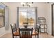 Cozy breakfast nook features a charming round table, seating for four, and ample natural light from the large window at 17773 W Manso St, Goodyear, AZ 85338