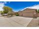 A well-maintained home featuring a three-car garage, xeriscaping, and clear driveway at 17773 W Manso St, Goodyear, AZ 85338